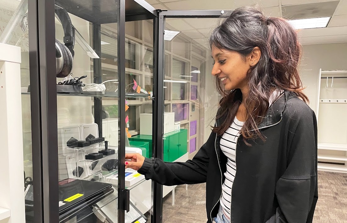 Shruthi Viswanathan, student assistant at Library Accessibility Services, can be seen browsing the assistive technology cabinet at the Campus Accessible Tech Space in Mills Memorial Library. 