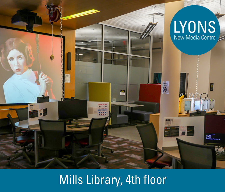 The inside of the Lyons New Media Centre, showing a bit of a view of the video wall and 3D printers in the background with computer stations in the foreground.