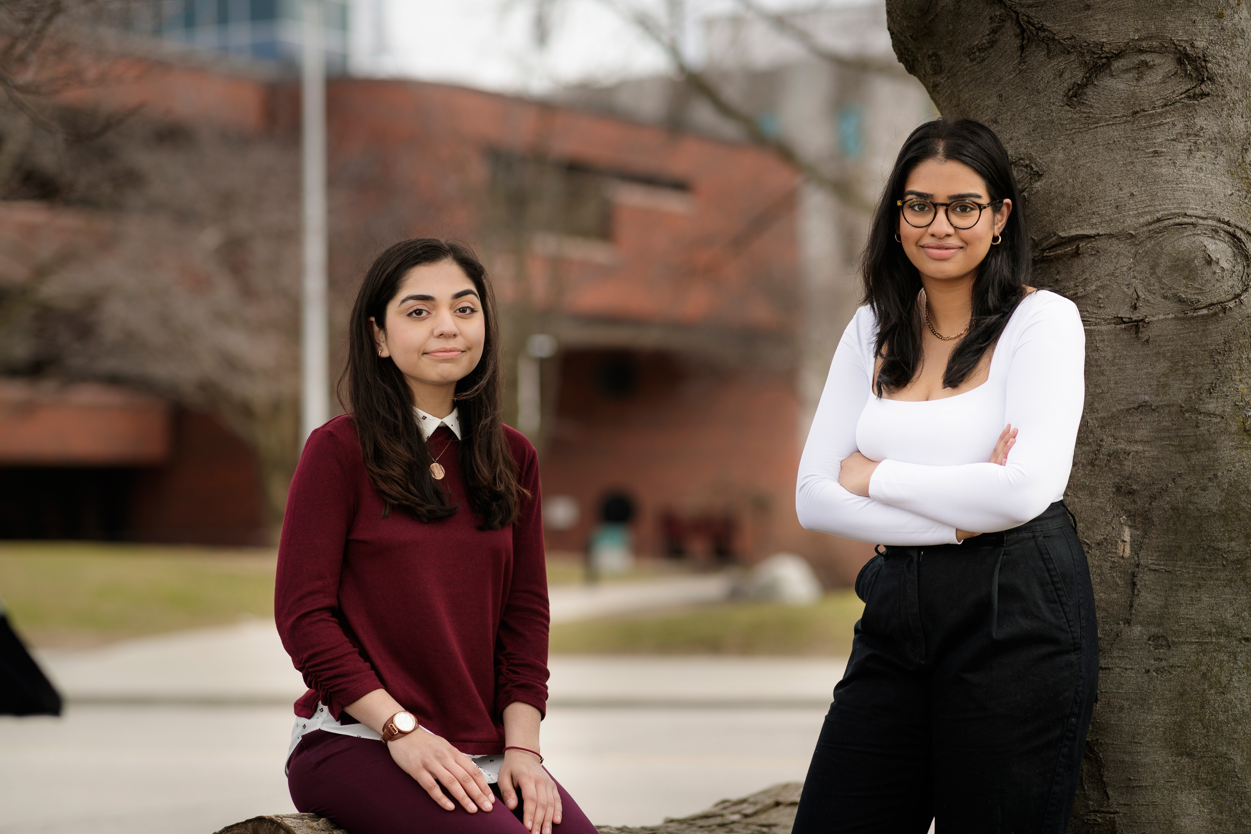 Noor and Lavanya, 2021-22 library ambassadors outside of Thode library can be seen.