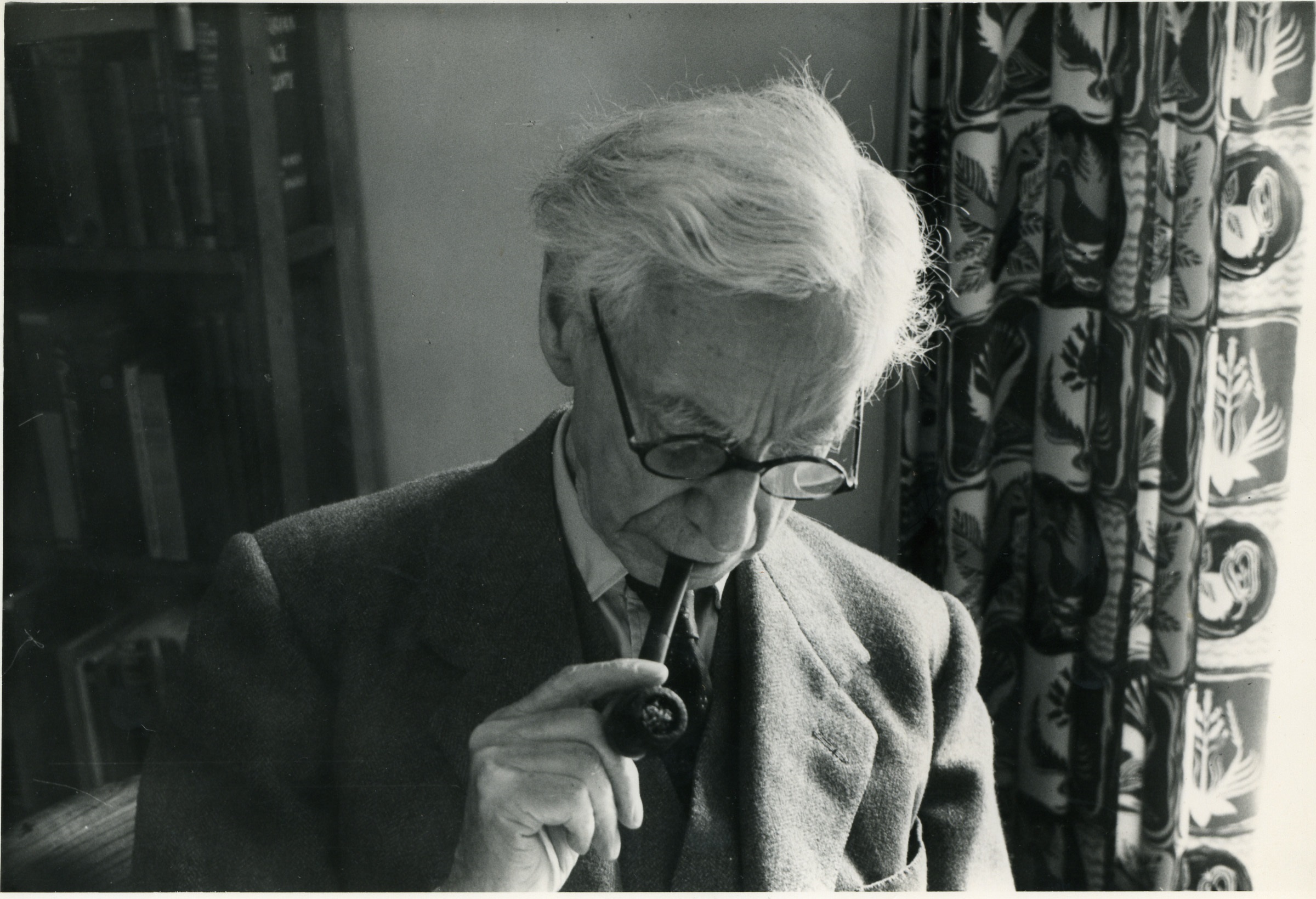Bertrand Russell smoking a pipe can be seen. 