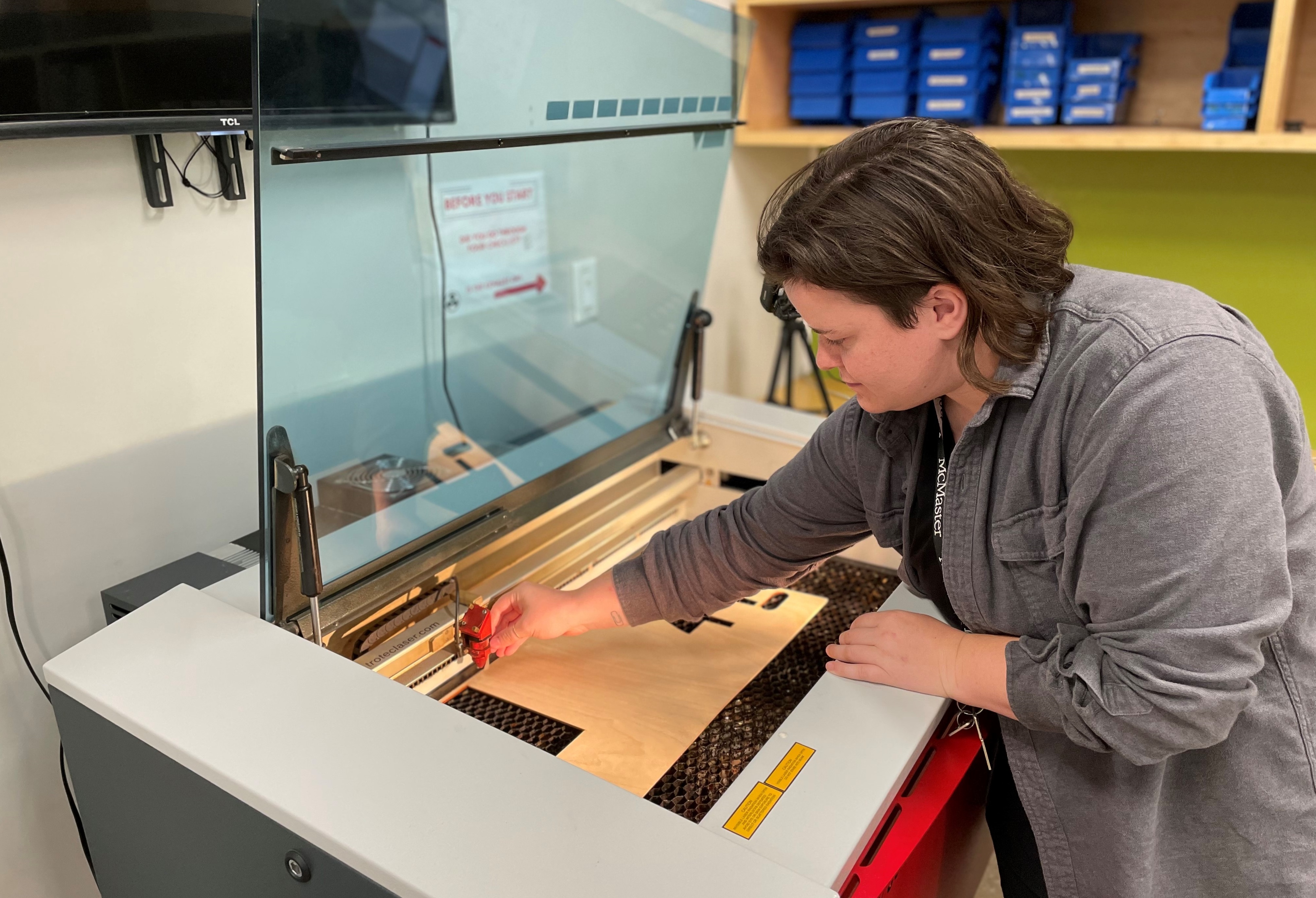 Brittany Sostar, Thode Makerspace coordinator, using the laser cutter/engraver in Makerspace.