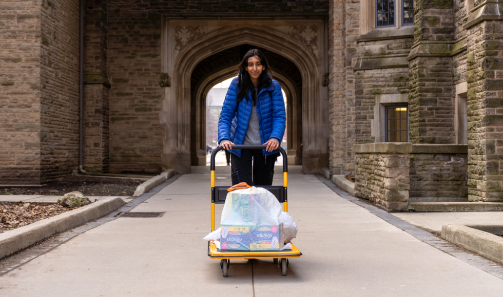 Fourth-year life sciences student Neha Dhanvanthry delivering menstrual hygiene products to different buildings on McMaster’s campus can be seen.
