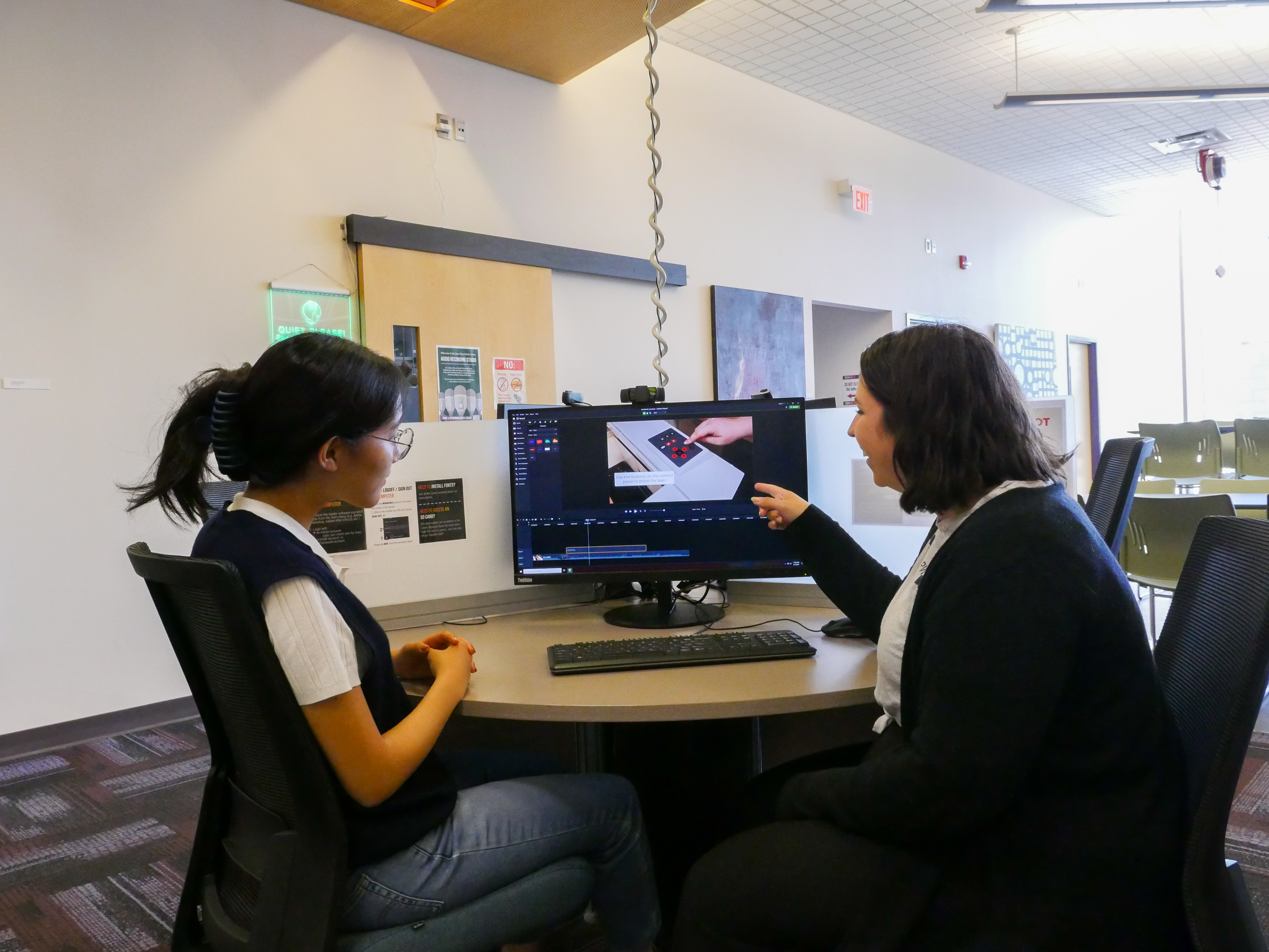 A Lyons media specialist assists a student with some media software on a computer in the Centre.