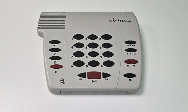 A rectangular device with black and red buttons