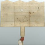 Verso of andwritten vellum document with seal at bottom, scalloped edge at top