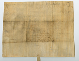 Handwritten vellum document with seal tag at bottom