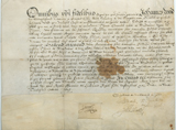 Handwritten vellum document with irregular stain in middle