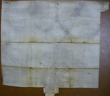 Verso of vellum document with evidence of folding and dirt accumulation