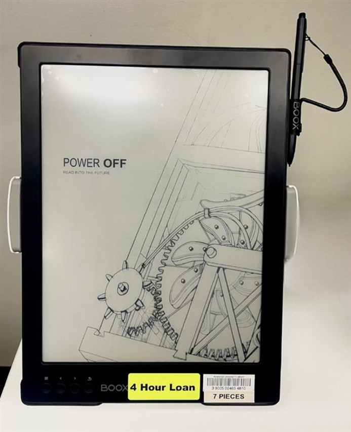 A BOOX concussion monitor with a pen attached to the right side, displaying a wallpaper featuring mechanical gears. A label at the bottom reads '4-hour loan,' and the box contains seven pieces