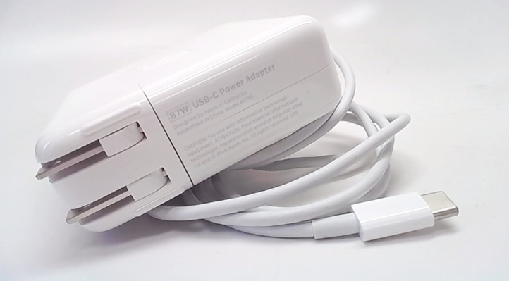 An Apple charger with its cable neatly coiled