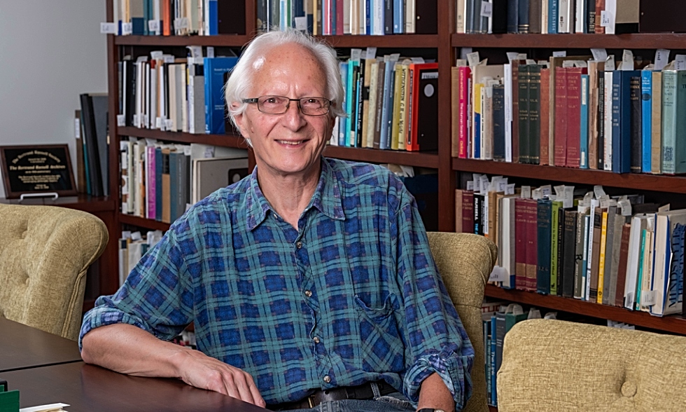 Nicholas Griffin sitting in front of bookshelves