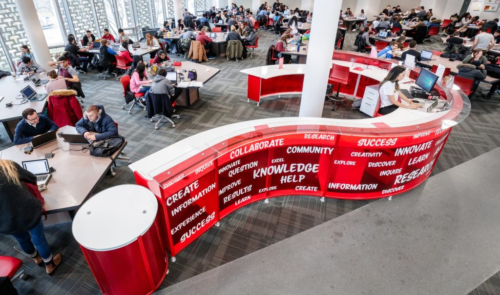 Question mark shaped help desk in Mills Learning Commons.